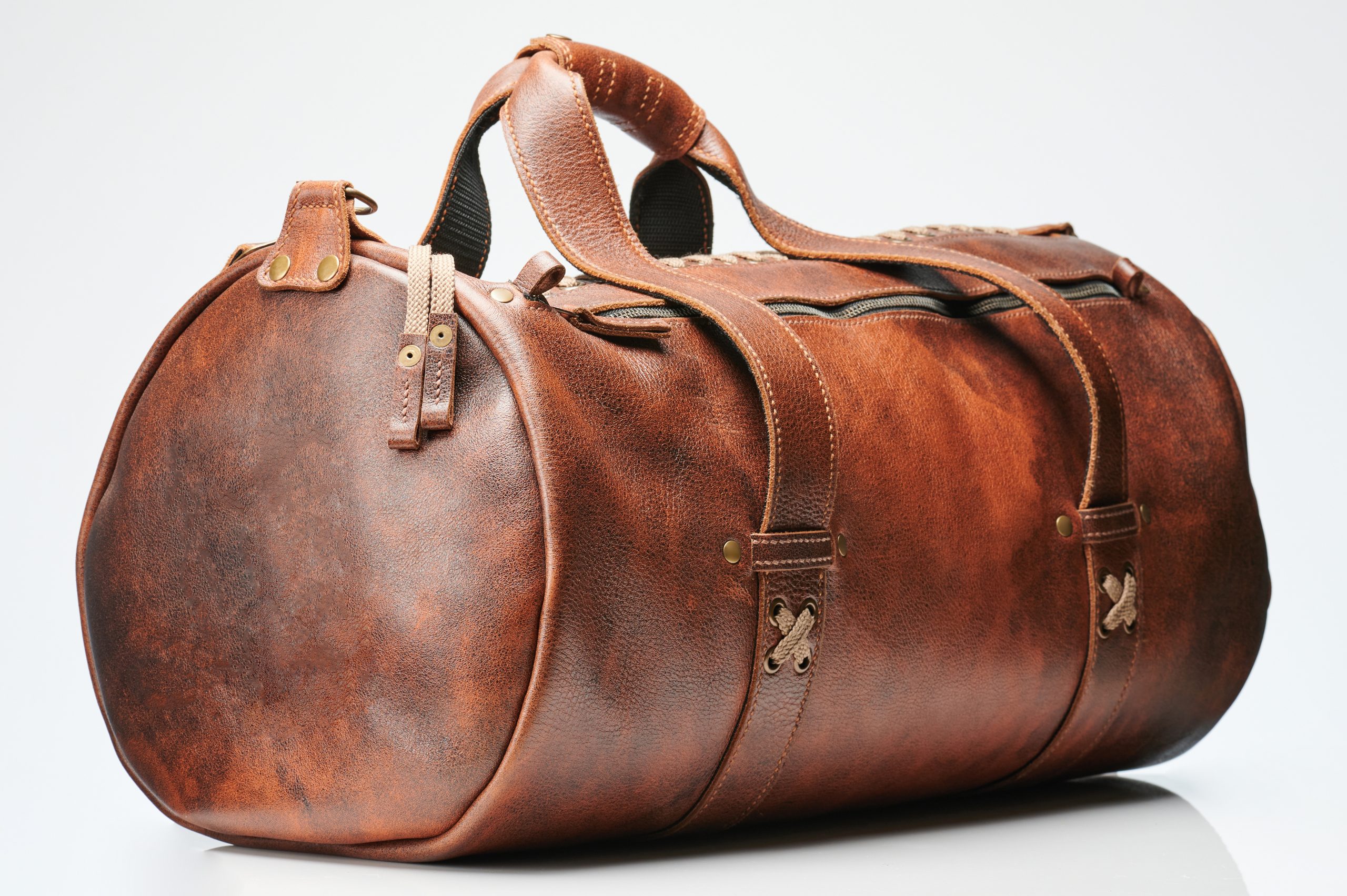 Brown leather luggage bag side view isolated on white studio background